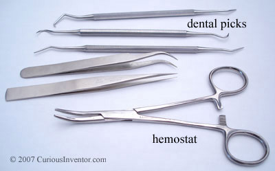 Dental picks, tweezers and a hemostat